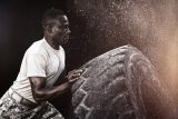 strong-man-flipping-over-a-large-truck-tire-160x107.jpg